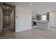 Open-concept living space flows into a kitchen featuring an island with gray cabinets and neutral tile flooring at 2570 E Music Mountain Ave, Apache Junction, AZ 85119