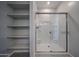Shower with clear glass door, white tile, and built-in shelving at 2570 E Music Mountain Ave, Apache Junction, AZ 85119
