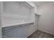 Walk-in closet with white shelves and carpeted floor at 2570 E Music Mountain Ave, Apache Junction, AZ 85119