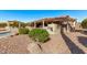 Expansive backyard with covered patio, built-in fireplace, mature landscaping and desert rock at 2890 N 156Th Dr, Goodyear, AZ 85395