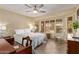 Bedroom with large window, shutters, and ceiling fan offering a well-lit, comfortable space at 2890 N 156Th Dr, Goodyear, AZ 85395