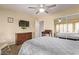 Bedroom with mirrored closet doors and ceiling fan, creating a cozy and functional space at 2890 N 156Th Dr, Goodyear, AZ 85395