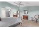 Stylish bedroom with blue walls, ceiling fan, and doorway to a dressing area or bathroom at 2890 N 156Th Dr, Goodyear, AZ 85395