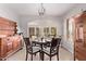 Charming dining room with round table, shuttered windows, decorative lighting, and wooden furniture at 2890 N 156Th Dr, Goodyear, AZ 85395