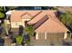 Aerial view of a well-maintained home with 3-car garage, tile roof, and landscaped yard at 2890 N 156Th Dr, Goodyear, AZ 85395