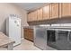 Functional laundry room featuring a washer, dryer, and ample cabinet space at 2890 N 156Th Dr, Goodyear, AZ 85395