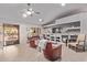 Cozy living room with vaulted ceiling, ceiling fan, built-in shelving, and access to outdoor area at 2890 N 156Th Dr, Goodyear, AZ 85395