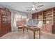 Well-lit home office with built-in shelving and a beautiful desk at 2890 N 156Th Dr, Goodyear, AZ 85395