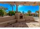 Inviting outdoor fireplace with seating area, perfect for entertaining and relaxing by the pool at 2890 N 156Th Dr, Goodyear, AZ 85395