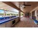 Covered outdoor kitchen with charming blue tiles and bar seating at 2890 N 156Th Dr, Goodyear, AZ 85395