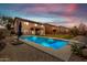 The backyard features a private pool, covered patio, and low-maintenance desert landscaping at 29767 W Amelia Ave, Buckeye, AZ 85396