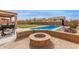 Backyard offers a firepit, in-ground pool, and barbecue space for outdoor fun at 29767 W Amelia Ave, Buckeye, AZ 85396