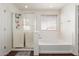 Bright bathroom featuring a shower and a soaking tub beneath a window at 29767 W Amelia Ave, Buckeye, AZ 85396