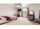 Bedroom with a ceiling fan, neutral carpet, and natural light from a window at 29767 W Amelia Ave, Buckeye, AZ 85396