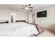 Spacious bedroom with plush carpet, ceiling fan, and ample natural light at 29767 W Amelia Ave, Buckeye, AZ 85396