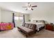 Comfortable bedroom with neutral walls and carpet, ceiling fan, and ample natural light at 29767 W Amelia Ave, Buckeye, AZ 85396