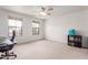 Bedroom featuring neutral carpet, two windows, and a five-blade ceiling fan at 29767 W Amelia Ave, Buckeye, AZ 85396