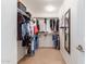 Narrow walk-in closet with shelving and clothes racks for efficient storage at 29767 W Amelia Ave, Buckeye, AZ 85396