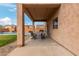 Covered patio features an outdoor dining set and direct access to the backyard pool at 29767 W Amelia Ave, Buckeye, AZ 85396