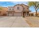 Inviting two-story home with a three-car garage and meticulously maintained front yard at 29767 W Amelia Ave, Buckeye, AZ 85396