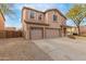 Beautiful two-story home featuring a three-car garage and easy-to-maintain desert landscape at 29767 W Amelia Ave, Buckeye, AZ 85396