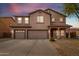 Stunning two-story home showcasing a spacious three-car garage and desert landscaping at 29767 W Amelia Ave, Buckeye, AZ 85396