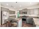 Modern kitchen with a center island, stainless steel appliances, and ample countertop space at 29767 W Amelia Ave, Buckeye, AZ 85396