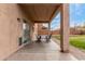 Covered outdoor patio with dining table and view of the backyard at 29767 W Amelia Ave, Buckeye, AZ 85396