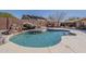 Private backyard oasis with a sparkling pool, rock feature, and patio area, perfect for relaxation and outdoor fun at 3116 W Folgers Rd, Phoenix, AZ 85027