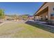 Large backyard showcasing the lawn, grill, hanging chairs, patio and lush landscaping at 3116 W Folgers Rd, Phoenix, AZ 85027