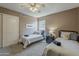 Bright bedroom featuring two twin beds, a ceiling fan, and neutral walls at 3116 W Folgers Rd, Phoenix, AZ 85027