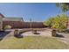 Relaxing backyard fire pit area with stone bench and landscaping at 3116 W Folgers Rd, Phoenix, AZ 85027