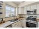 Kitchen featuring stainless steel appliances, butcher block counters, and a view of the backyard at 3116 W Folgers Rd, Phoenix, AZ 85027