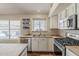 Well-lit kitchen featuring stainless steel appliances, butcher block counters, and a view of the backyard at 3116 W Folgers Rd, Phoenix, AZ 85027