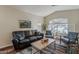 Bright and airy living room featuring hardwood floors, neutral walls, and a large window, providing a cozy and stylish space at 3116 W Folgers Rd, Phoenix, AZ 85027