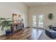 Bright living room with hardwood floors, double doors, and neutral walls at 3116 W Folgers Rd, Phoenix, AZ 85027