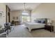 Spacious main bedroom featuring a ceiling fan, natural light, and sitting area at 3116 W Folgers Rd, Phoenix, AZ 85027