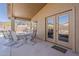 Covered outdoor patio with large dining table and seating area with view of solar panels at 3116 W Folgers Rd, Phoenix, AZ 85027