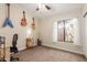 Bedroom with guitars mounted on the wall and a window with sheer curtains at 32 E Dawn Dr, Tempe, AZ 85284