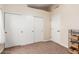 Bedroom featuring a sliding door closet and neutral carpeted flooring at 32 E Dawn Dr, Tempe, AZ 85284