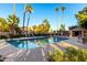 Beautiful community pool surrounded by mature trees and lounge chairs at 32 E Dawn Dr, Tempe, AZ 85284