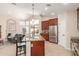 Modern kitchen featuring a large island with bar seating, stainless steel appliances, and a view into the living room at 32 E Dawn Dr, Tempe, AZ 85284