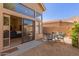 Back patio with gravel and outdoor furniture and a sliding glass door at 32 E Dawn Dr, Tempe, AZ 85284