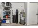 Utility room featuring a water heater, water filtration, and storage at 32 E Dawn Dr, Tempe, AZ 85284