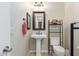 Powder bathroom with a pedestal sink and decorative shelves at 3234 N 163Rd Dr, Goodyear, AZ 85395