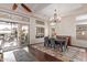 Elegant dining room with a modern chandelier and easy access to the outdoor patio at 3234 N 163Rd Dr, Goodyear, AZ 85395