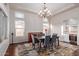 Dining area featuring stylish furnishings, built-in bar, and abundant natural light from large windows at 3234 N 163Rd Dr, Goodyear, AZ 85395