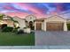 Stunning single-story home showcasing meticulously landscaped grounds and a beautiful paver driveway at 3234 N 163Rd Dr, Goodyear, AZ 85395