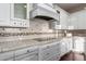 Kitchen featuring white cabinets, tile backsplash, granite countertops, and stainless steel appliances at 3234 N 163Rd Dr, Goodyear, AZ 85395