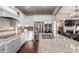 Modern kitchen featuring stainless steel appliances, granite counters, island, and white cabinets at 3234 N 163Rd Dr, Goodyear, AZ 85395